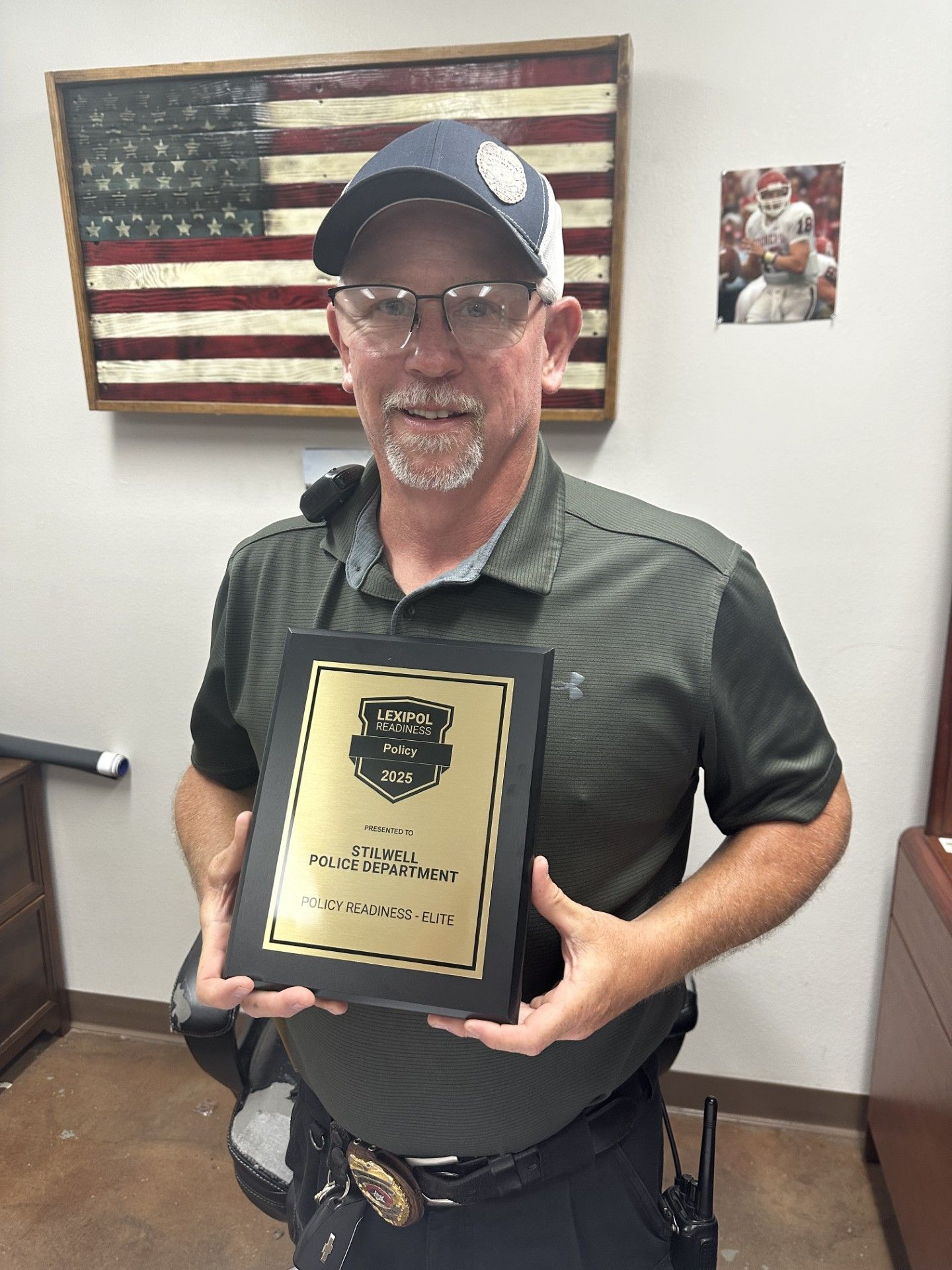 Stilwell Chief of Police Chad Smith with the department's Lexipol award.