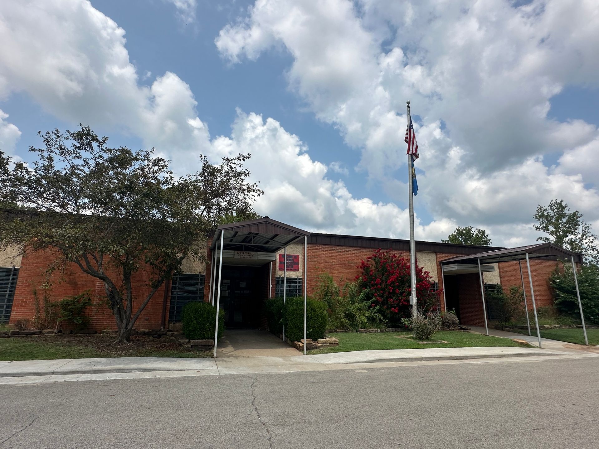 Human Figurines Standing on Wooden Plank photo of Stilwell OK community center building