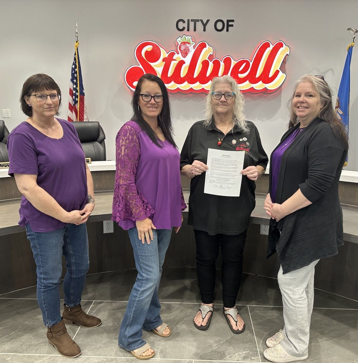 Mayor Jean Ann Wright signs a citation declaring October Domestic Violence Prevention Month in Stilwell.