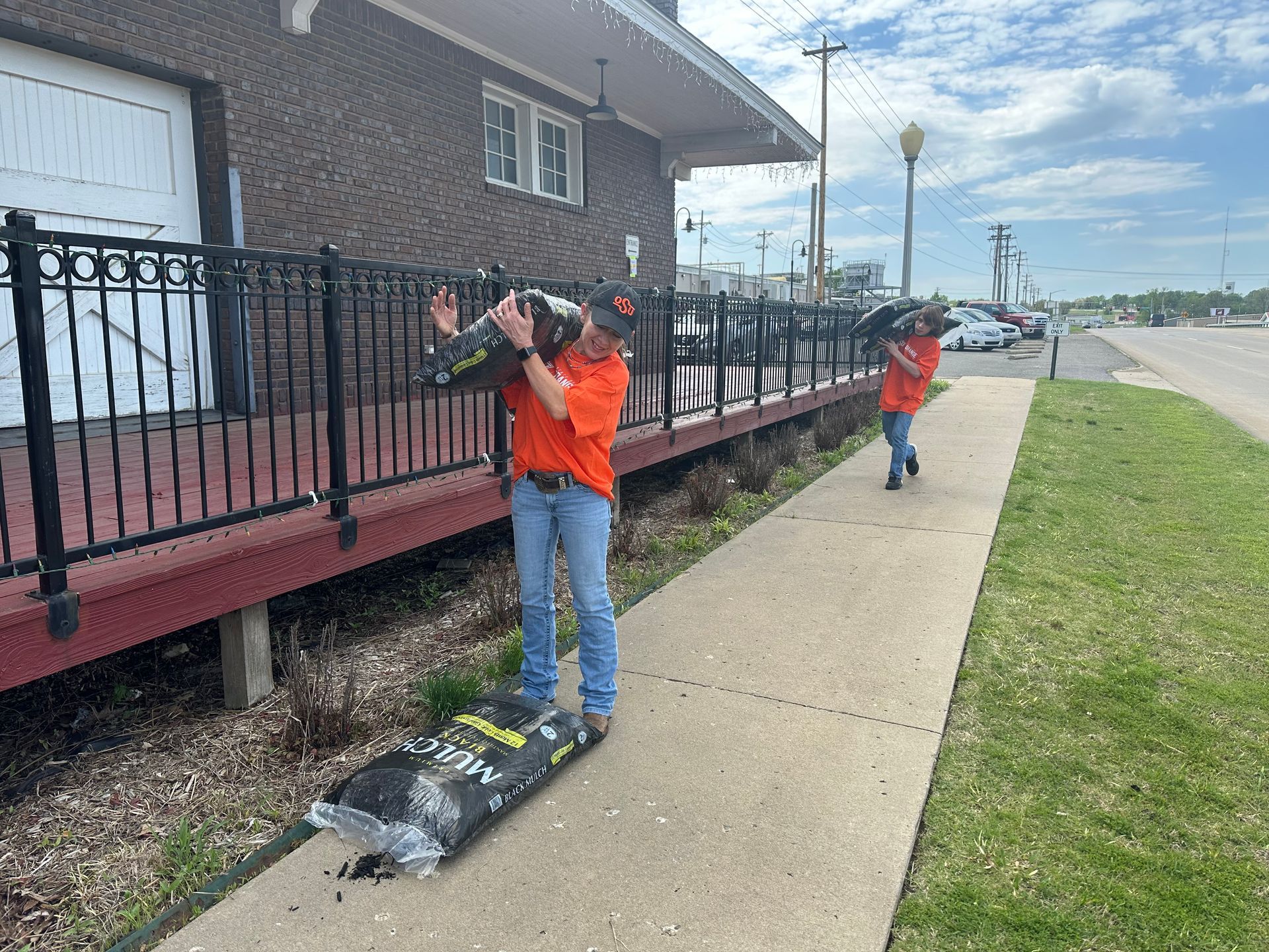 Photo of landscaping workers at the historic Stilwell OK train depot