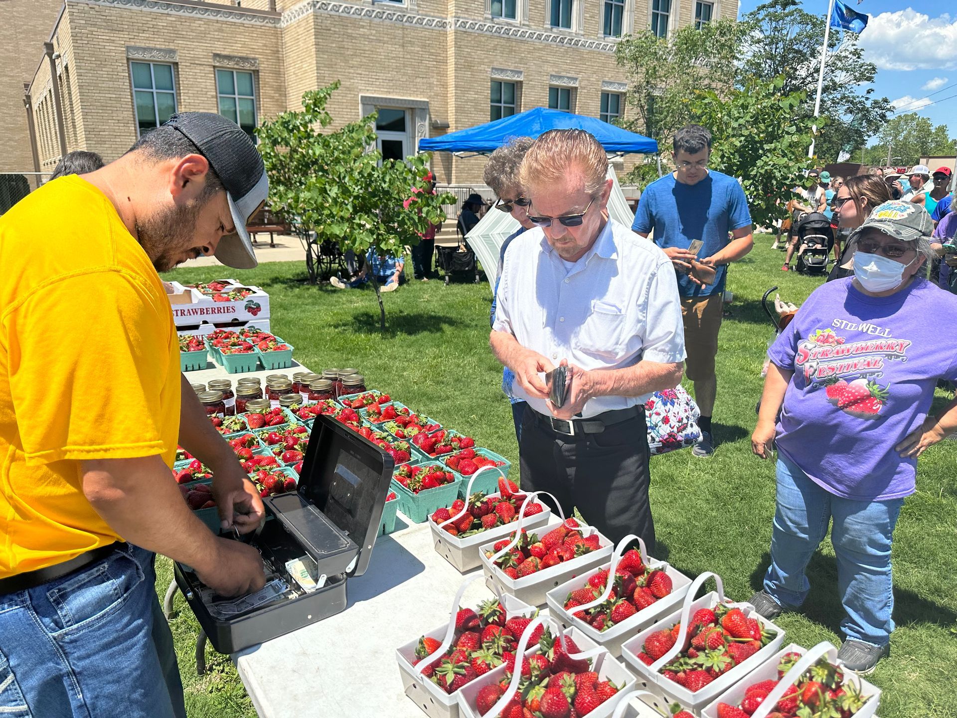 click to zoom in Tables full of strawberries being sold at the annual Strawberry Festival