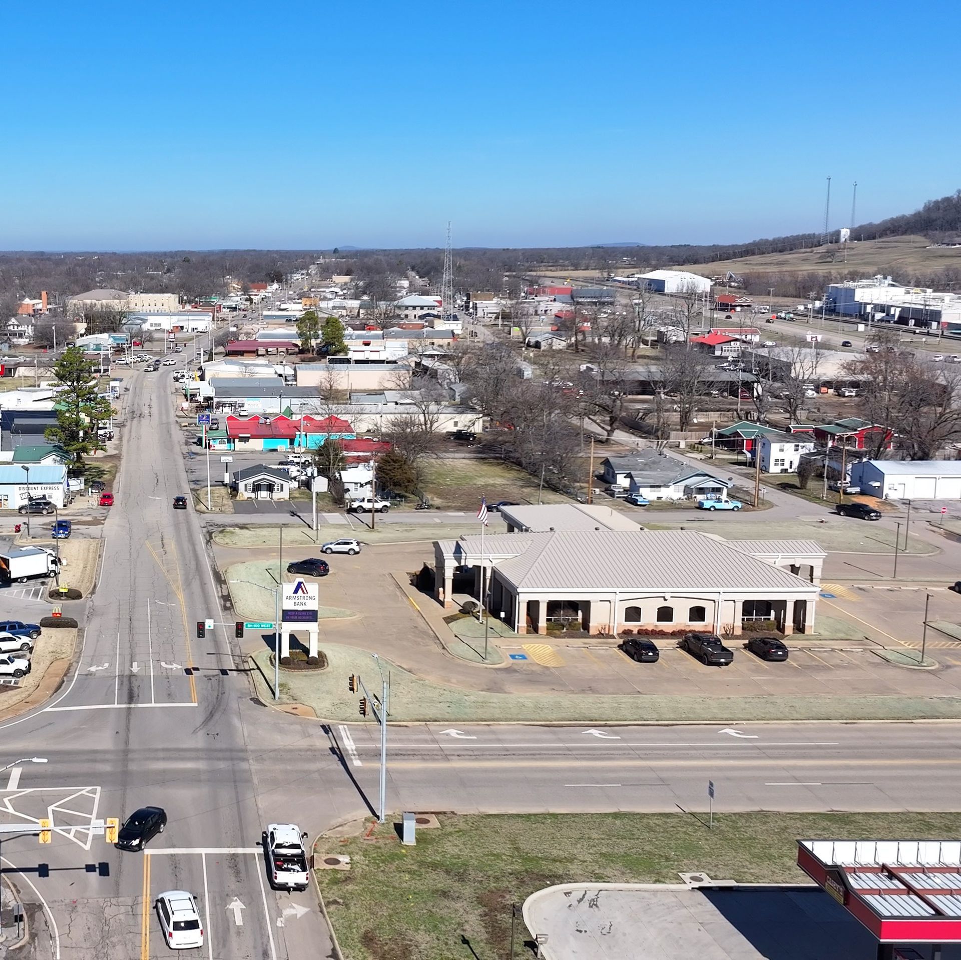 Human Figurines Standing on Wooden Plank Aerial photo of 2nd Street and Hwy 100