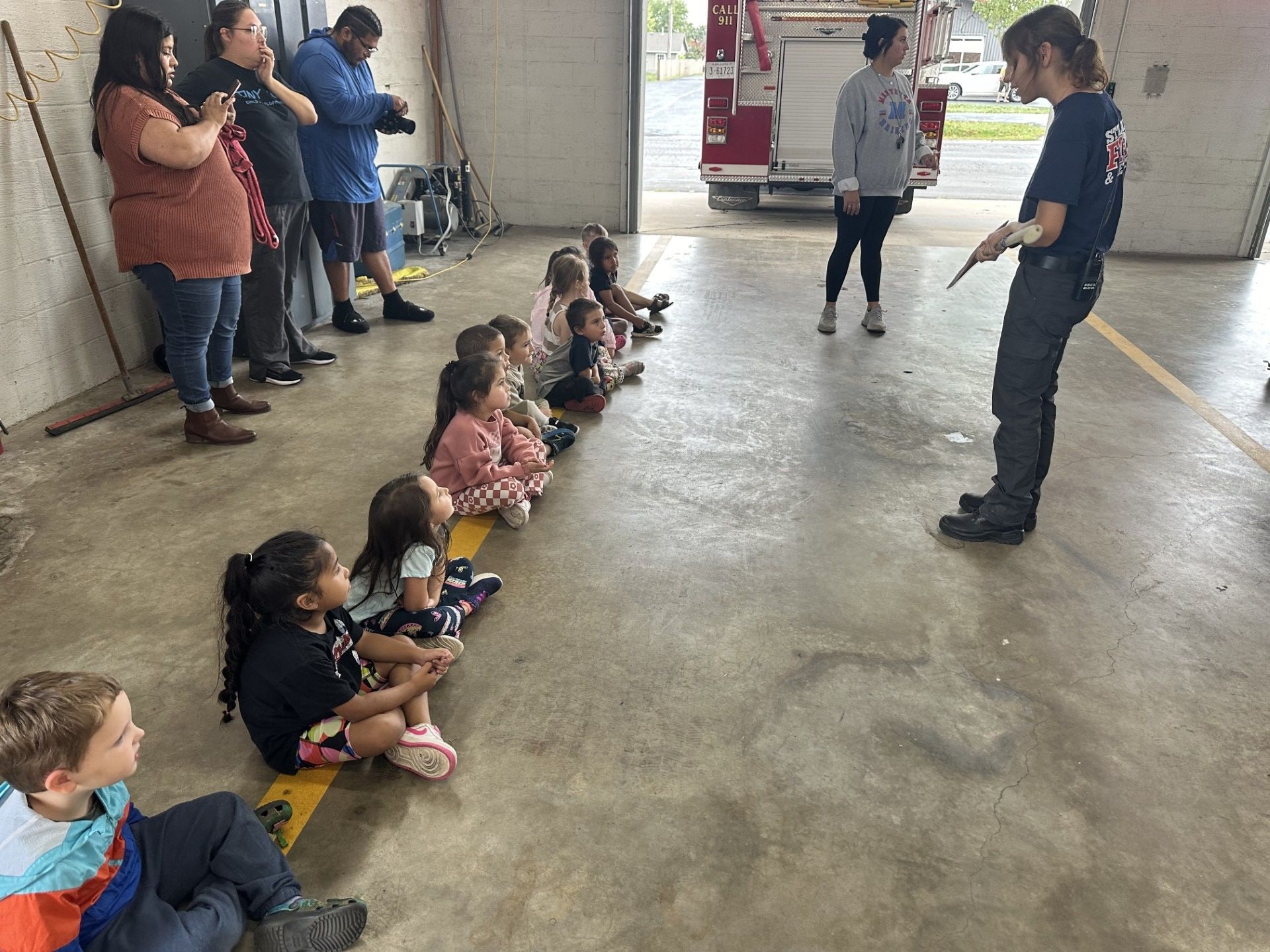 A Stilwell Oklahoma firefighter showing students a hatchet.
Cherokee Nation Family Advocates Valerie Robertson, Shelly Hummingbird and Terri Fourkiller work at Maryetta School and were on hand to help with the kids.
“This is such a good opportunity for the kids to learn safety and get used to firefighters in case they’re ever in a fire, so they won’t be so scared if ever they’re in that situation,” said Robertson.
In between taking pictures of the kids on the fire truck, Fredricks said she likes to bring the kids to the fire station.
“We learn about fire safety at school, and this gives them more of a visual, more hands-on activities. And they get to see the firemen,” said Fredricks.