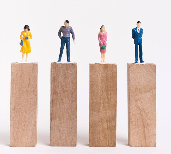 Human Figurines Standing on Wooden Plank Human Figurines Standing on Wooden Plank