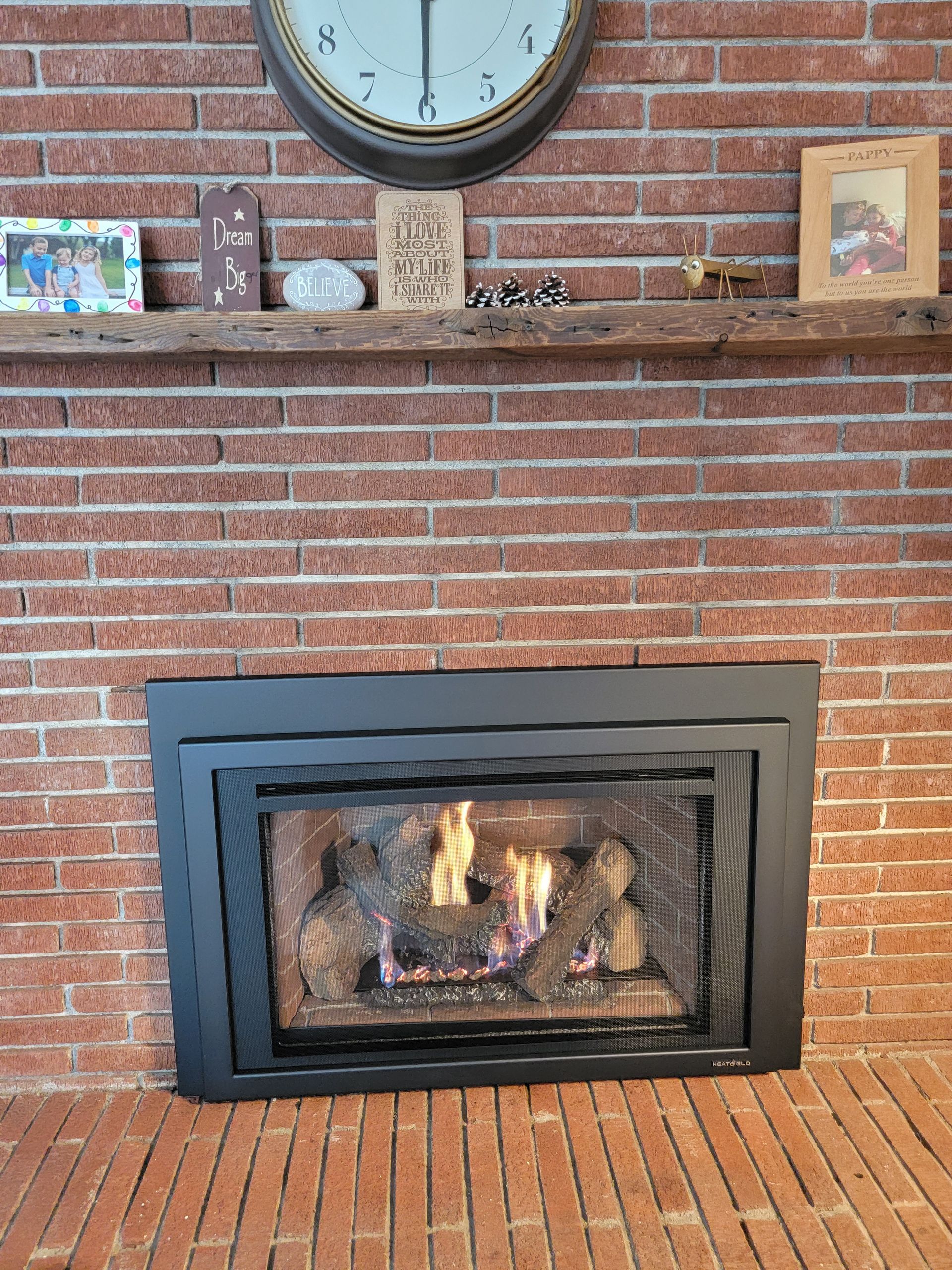 A fireplace in a living room with a clock above it.