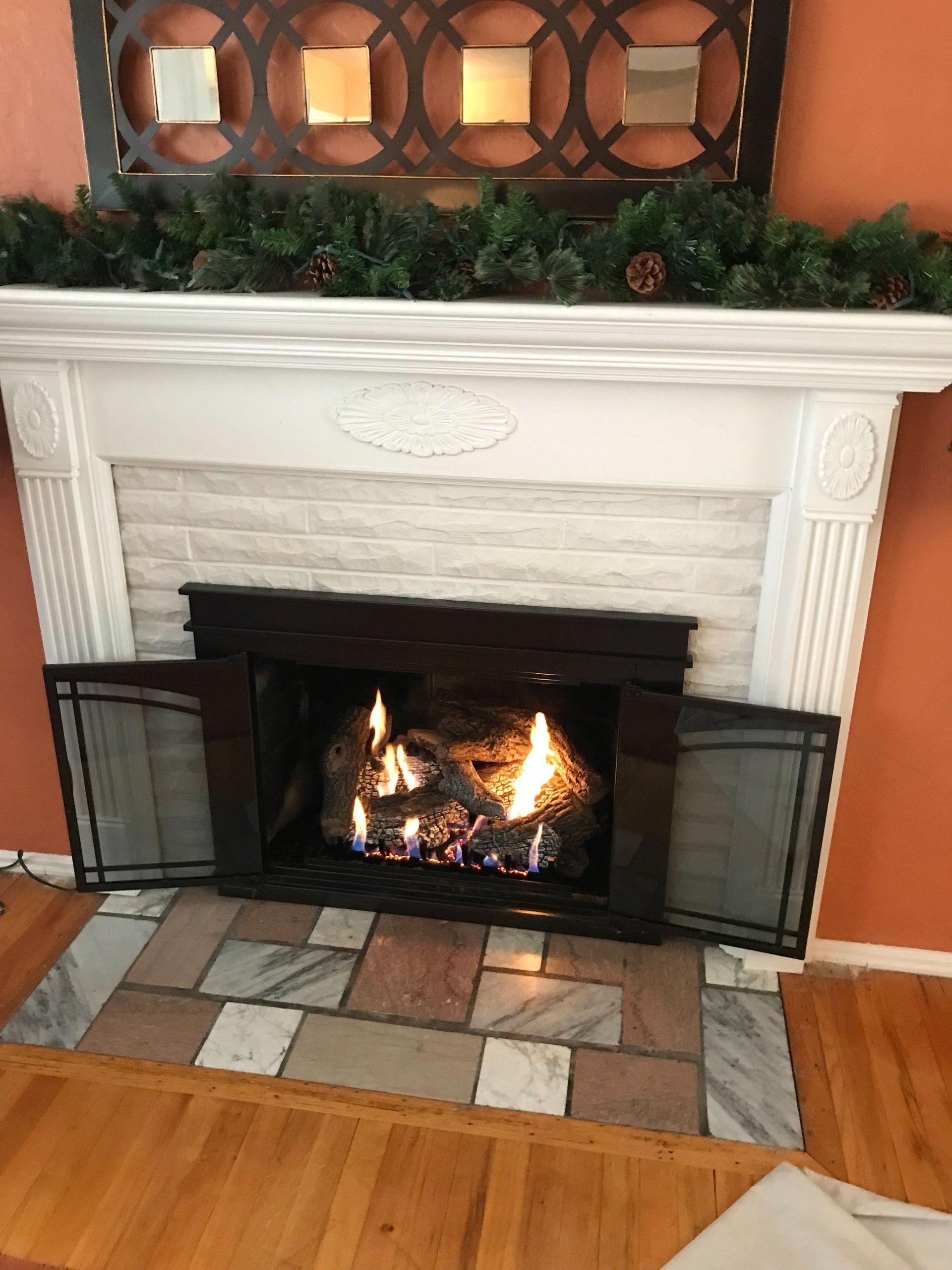 A living room with a fireplace and a mantle.