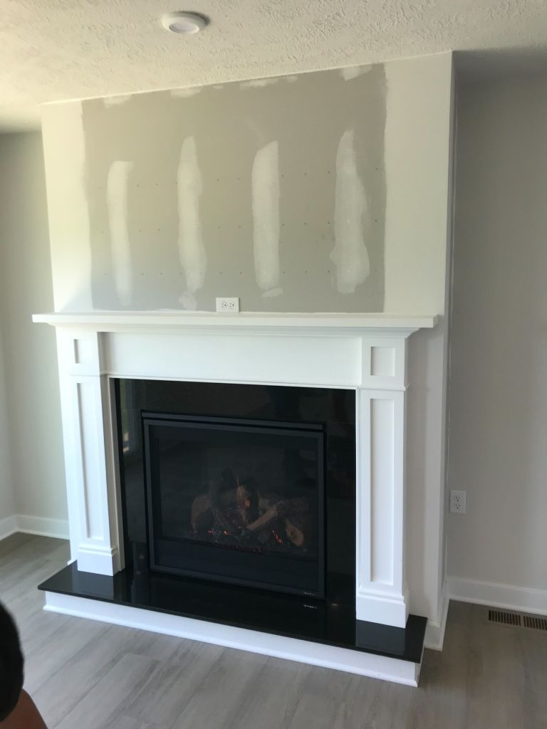 There is a fireplace in the middle of the room.