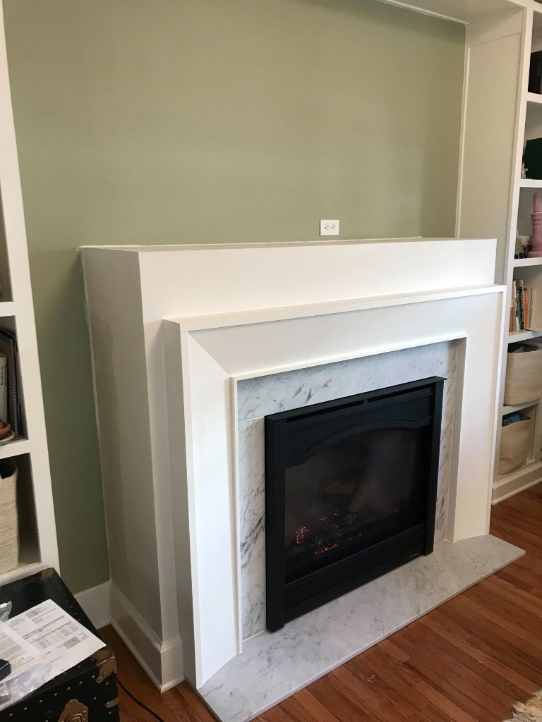 There is a fireplace in the middle of the room.