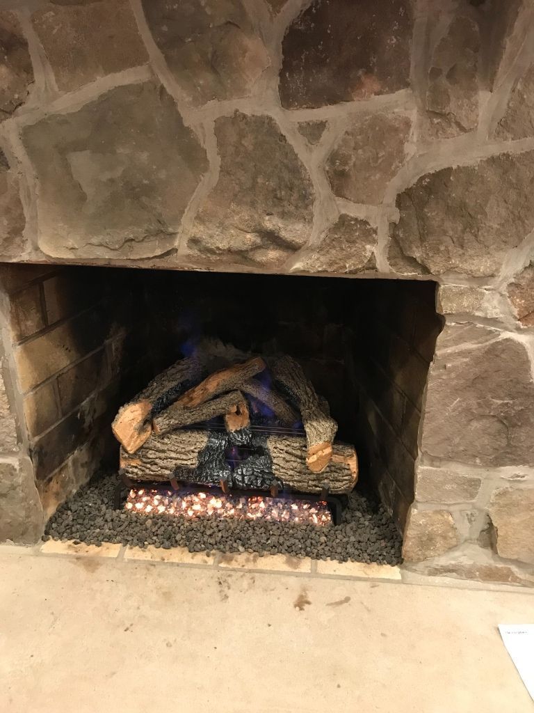 A fireplace with a lot of logs in it