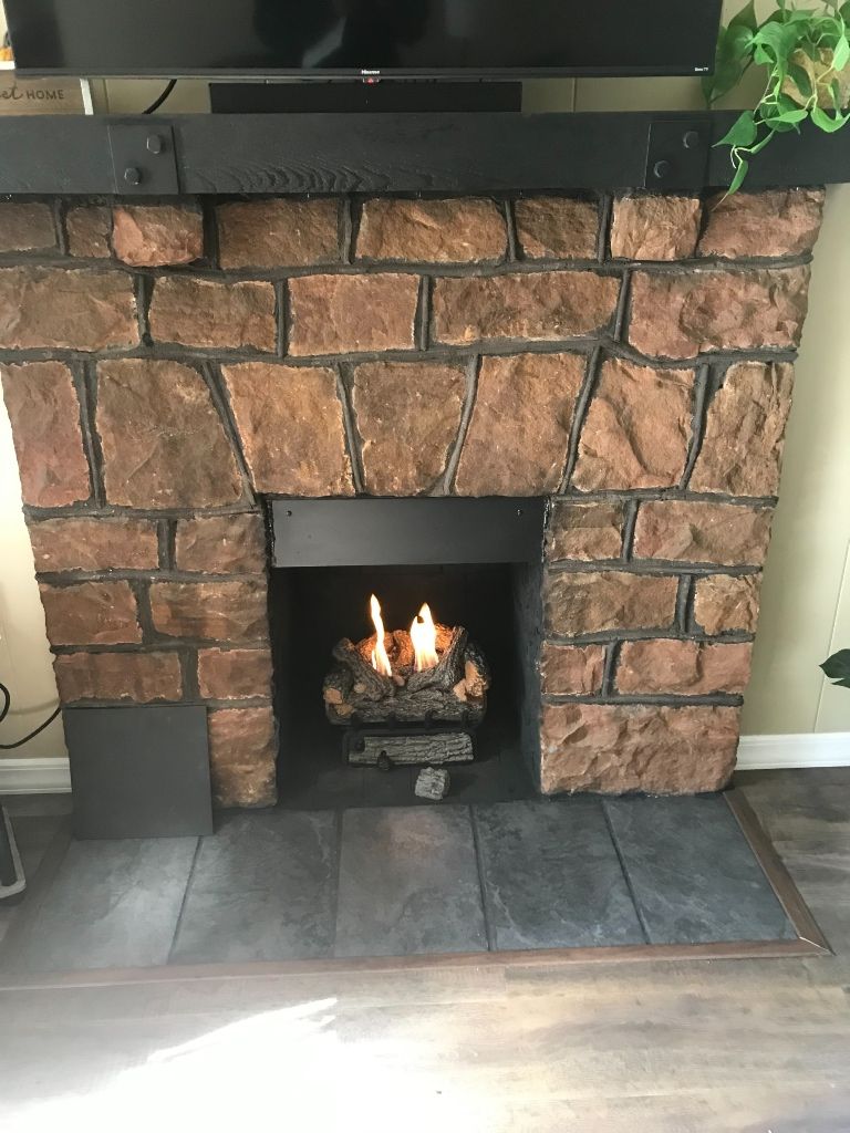 A living room with a fireplace and a flat screen tv.
