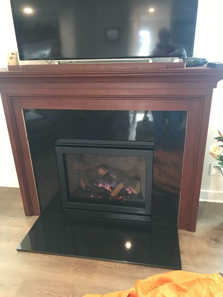 A fireplace with a television on top of it in a living room.