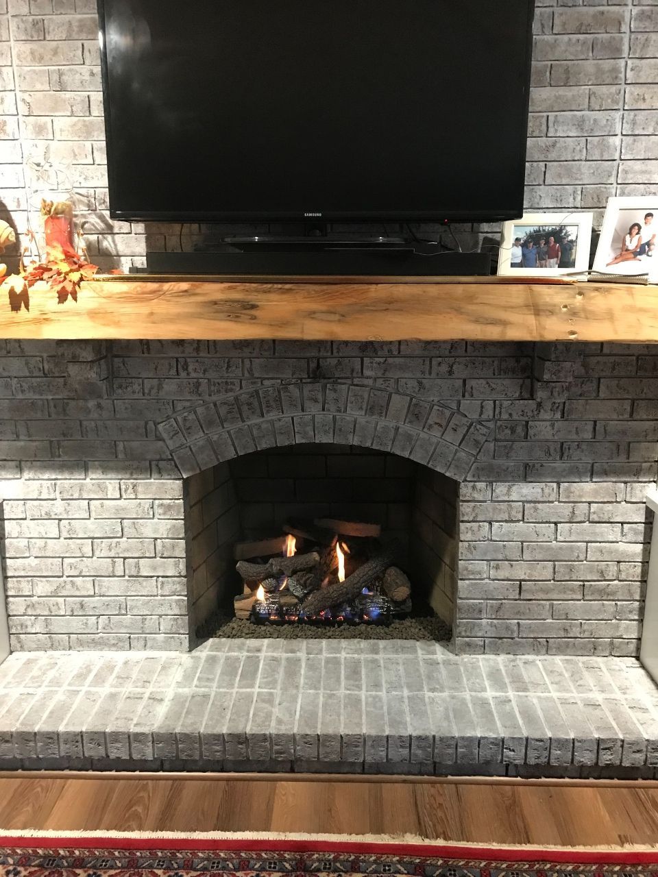 A living room with a fireplace and a flat screen tv.