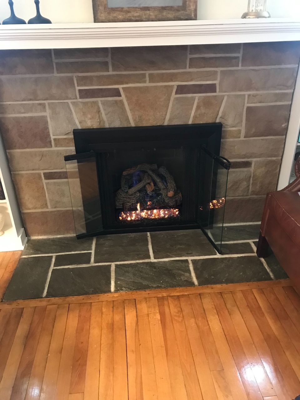 A fireplace in a living room with a wooden floor
