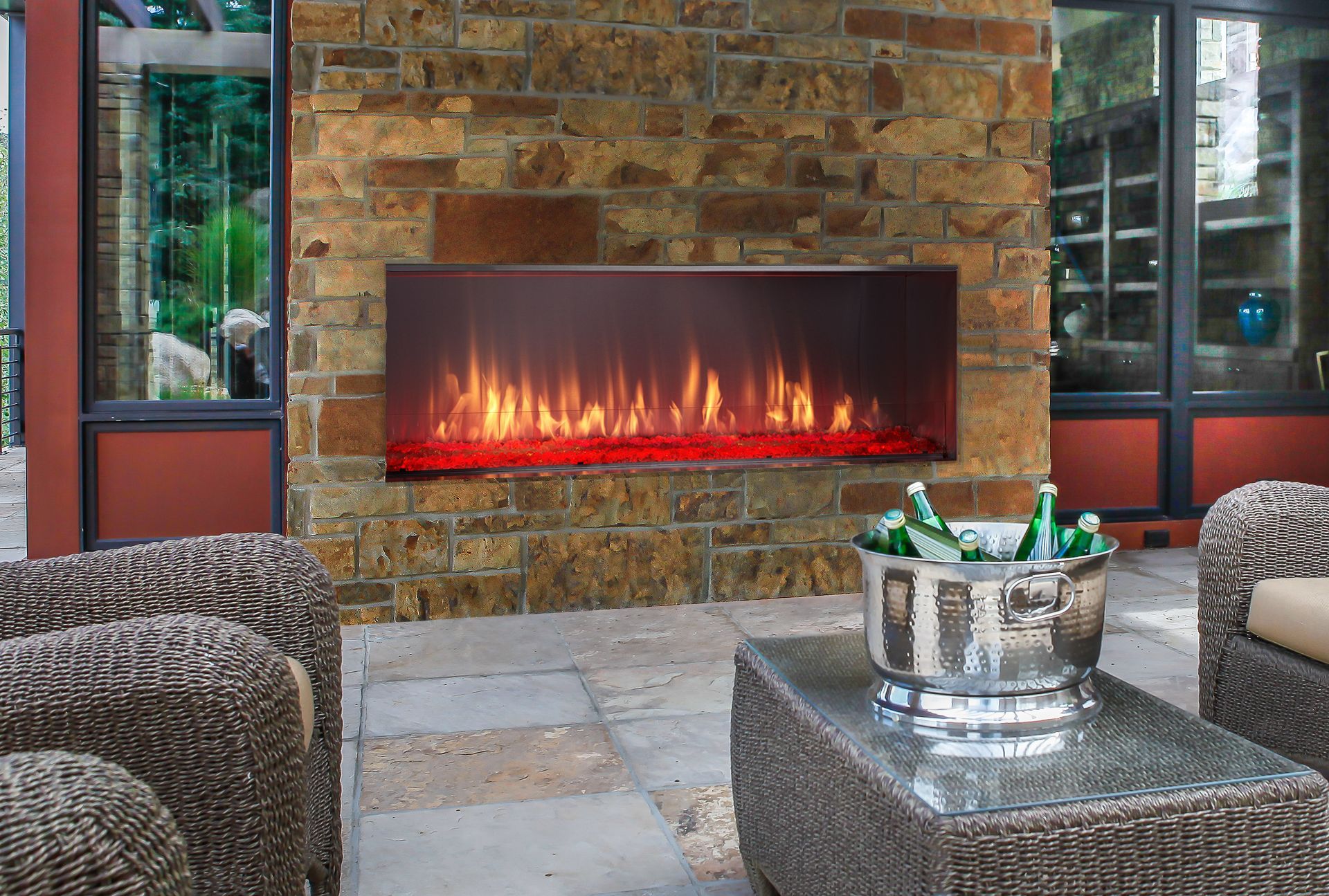 A fireplace with a bucket of beer on a table in front of it