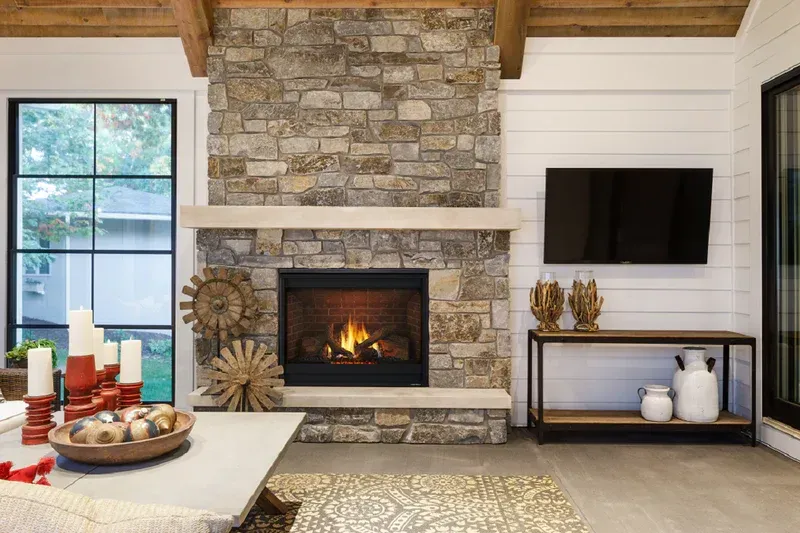 A living room with a fireplace and a flat screen tv.