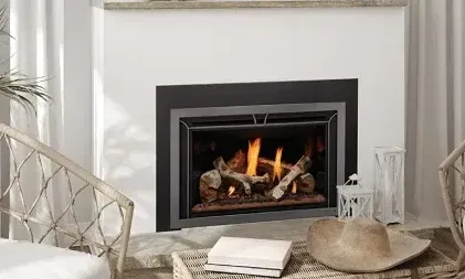 A living room with a fireplace , chairs , books and a hat.