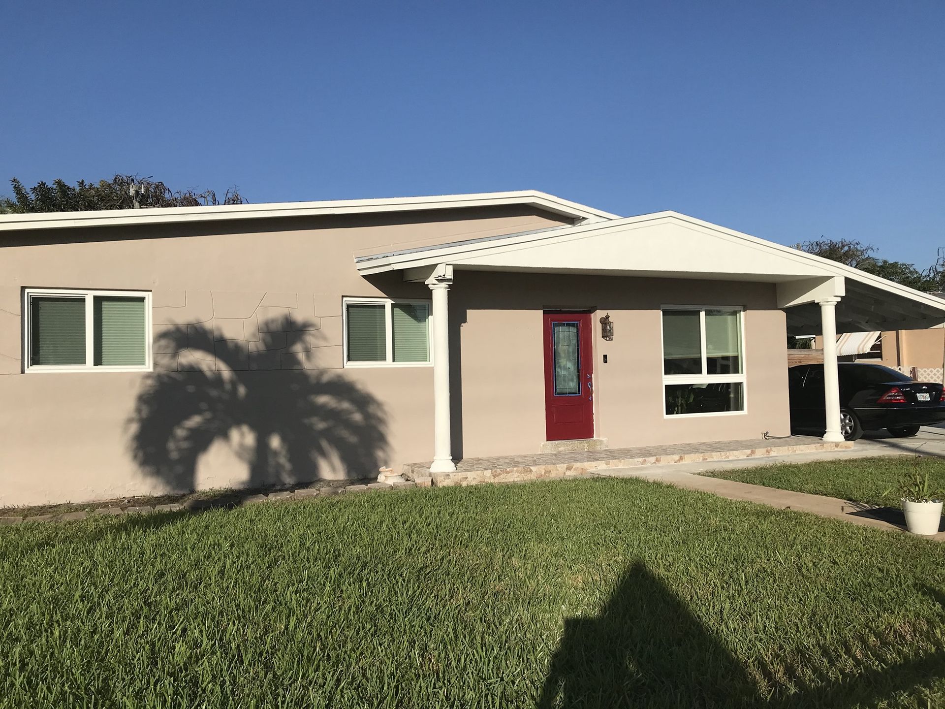 A house with a red door and a white roof