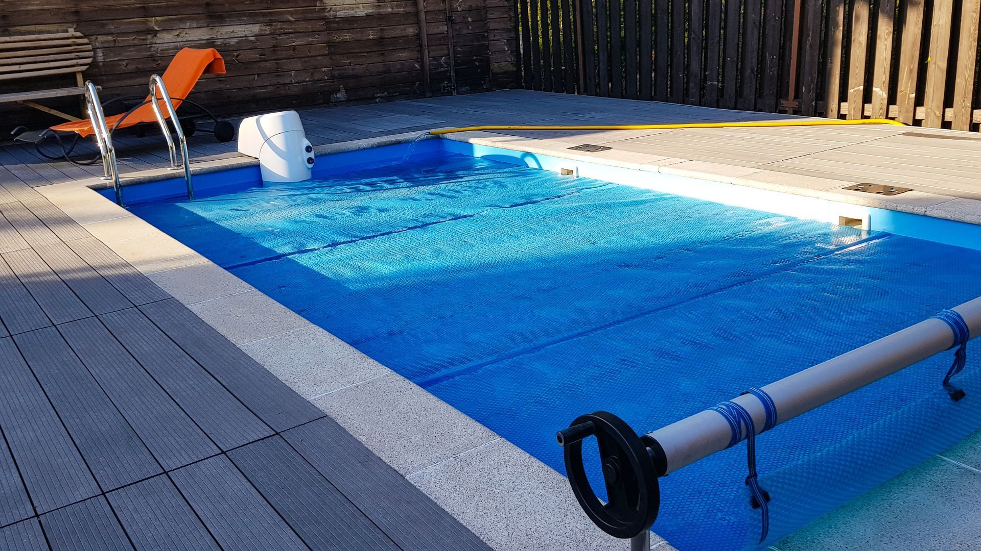 A swimming pool with a blue cover on it