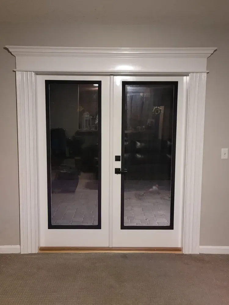 A pair of white sliding glass doors in a living room.