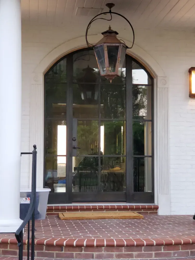 A door with a lantern hanging from the ceiling