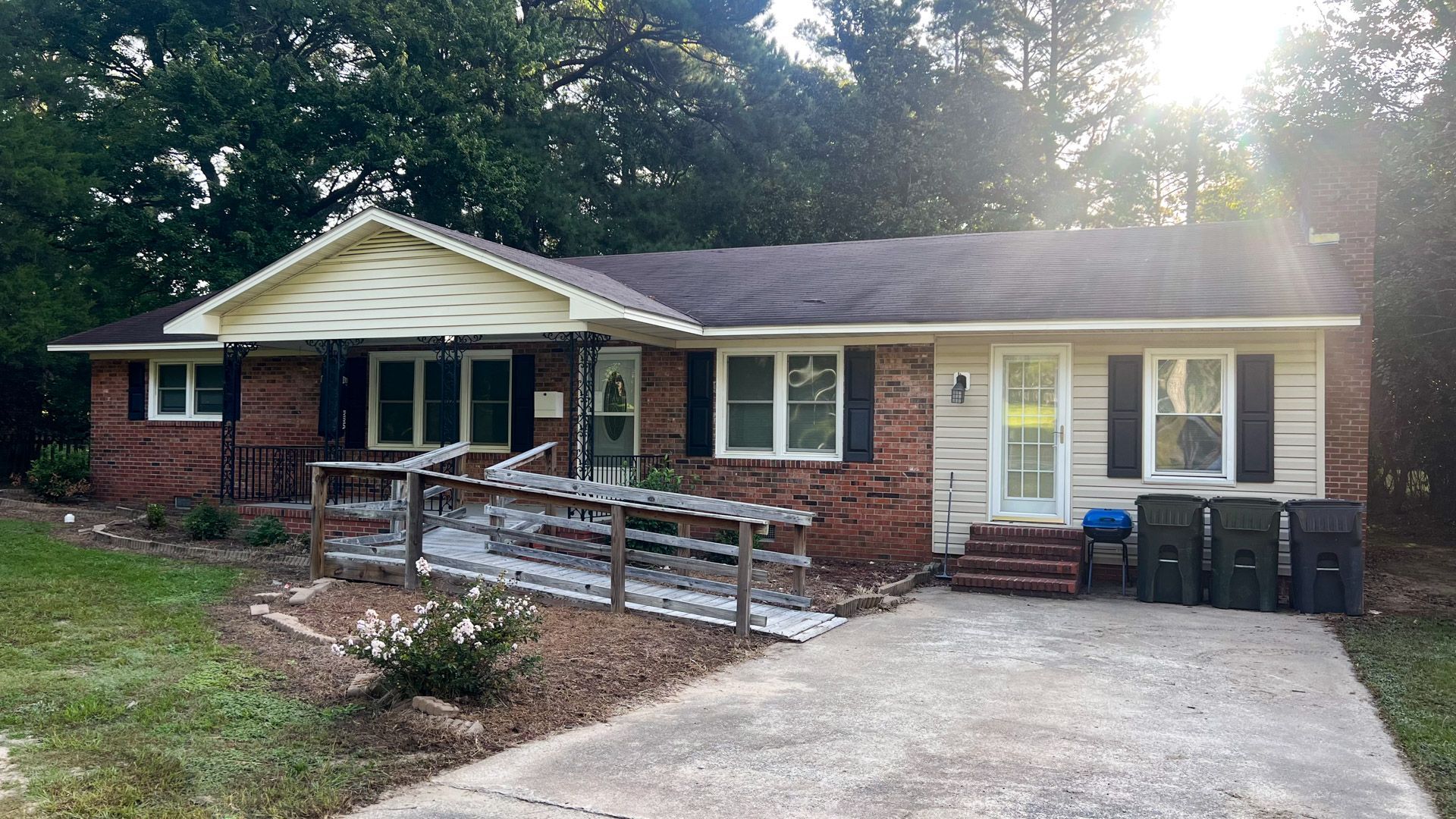 A brick house with a handicap ramp in front of it.
