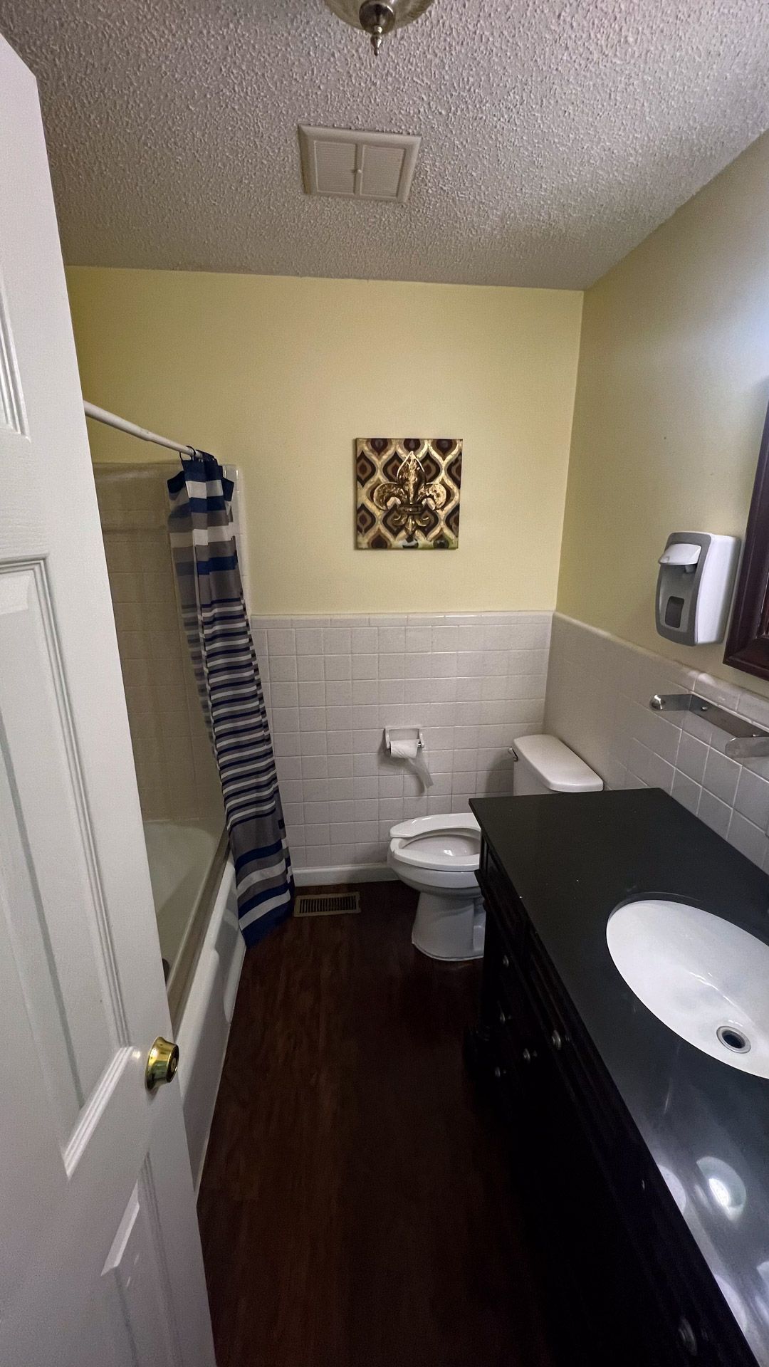 A bathroom with a toilet , sink , and shower.