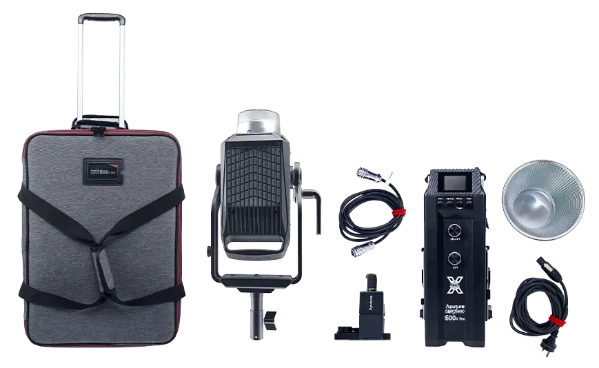 Black and gray portable studio light kit with wheeled case, lamp, power cords, and accessories laid out
