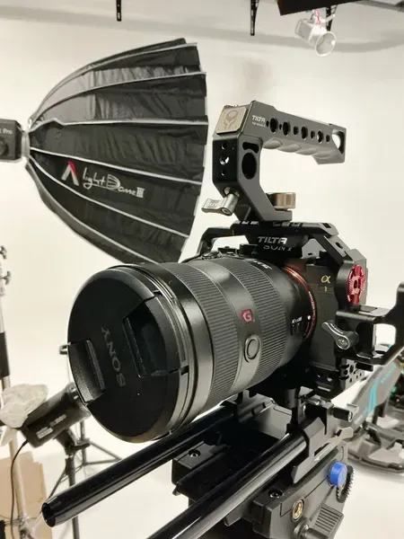 Professional camera on a slider with a large softbox light in a studio setup