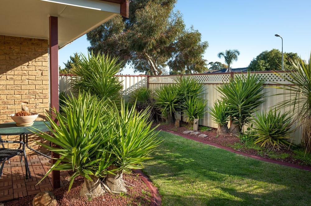 A Sunny Backyard Patio With a Brick Floor — Old Mates Grass Cutters in Deeragun, QLD