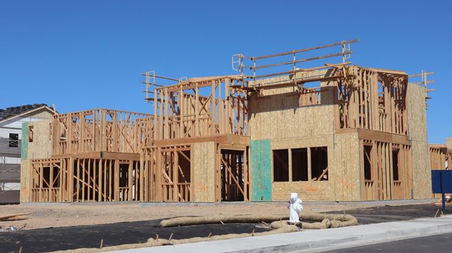 Wood-framed house under construction on a suburban lot