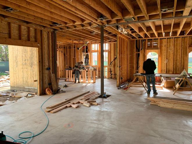 Interior of a house under construction with exposed wood framing