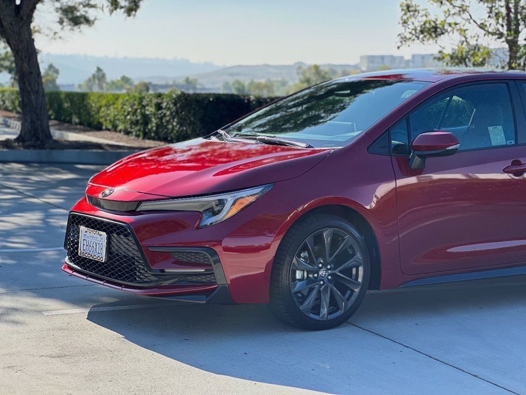 Red Toyota Corolla parked outdoors.