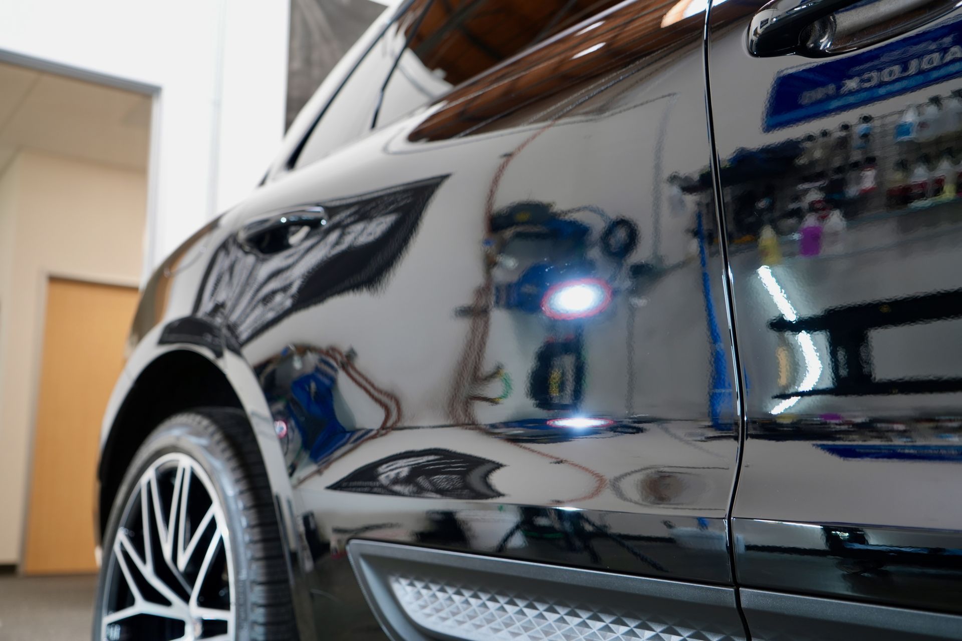 A black and white car is parked in a garage.