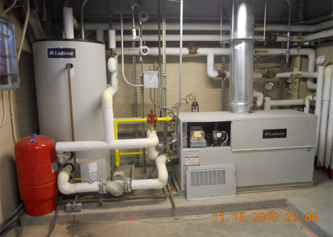 Heating system in a utility room; includes a water heater, boiler, and associated pipes.