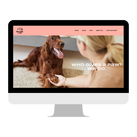 Website on a monitor showing a dog with a woman holding its paw. Text: 