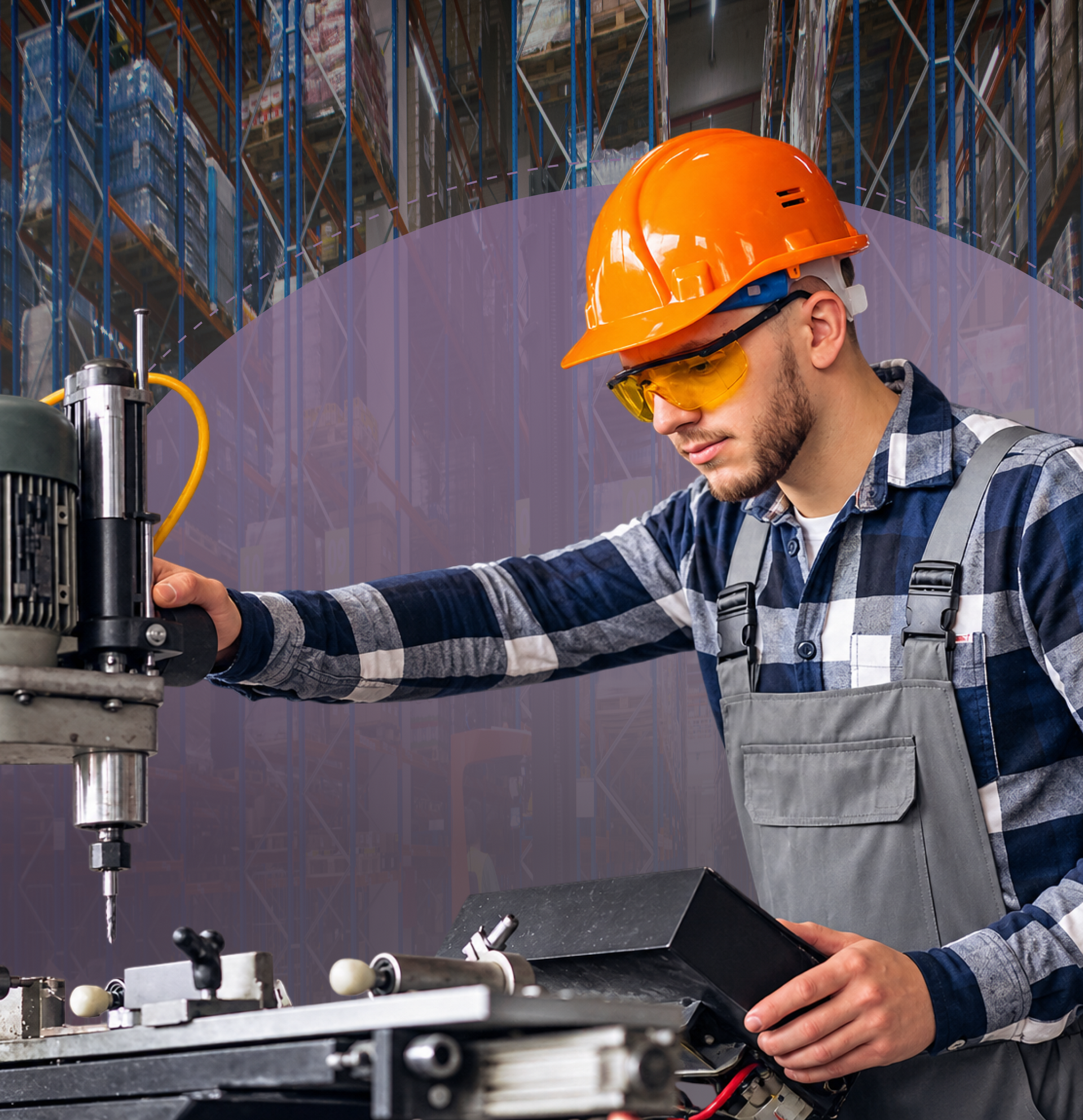 Worker in orange hard hat operating a drill press in a workshop