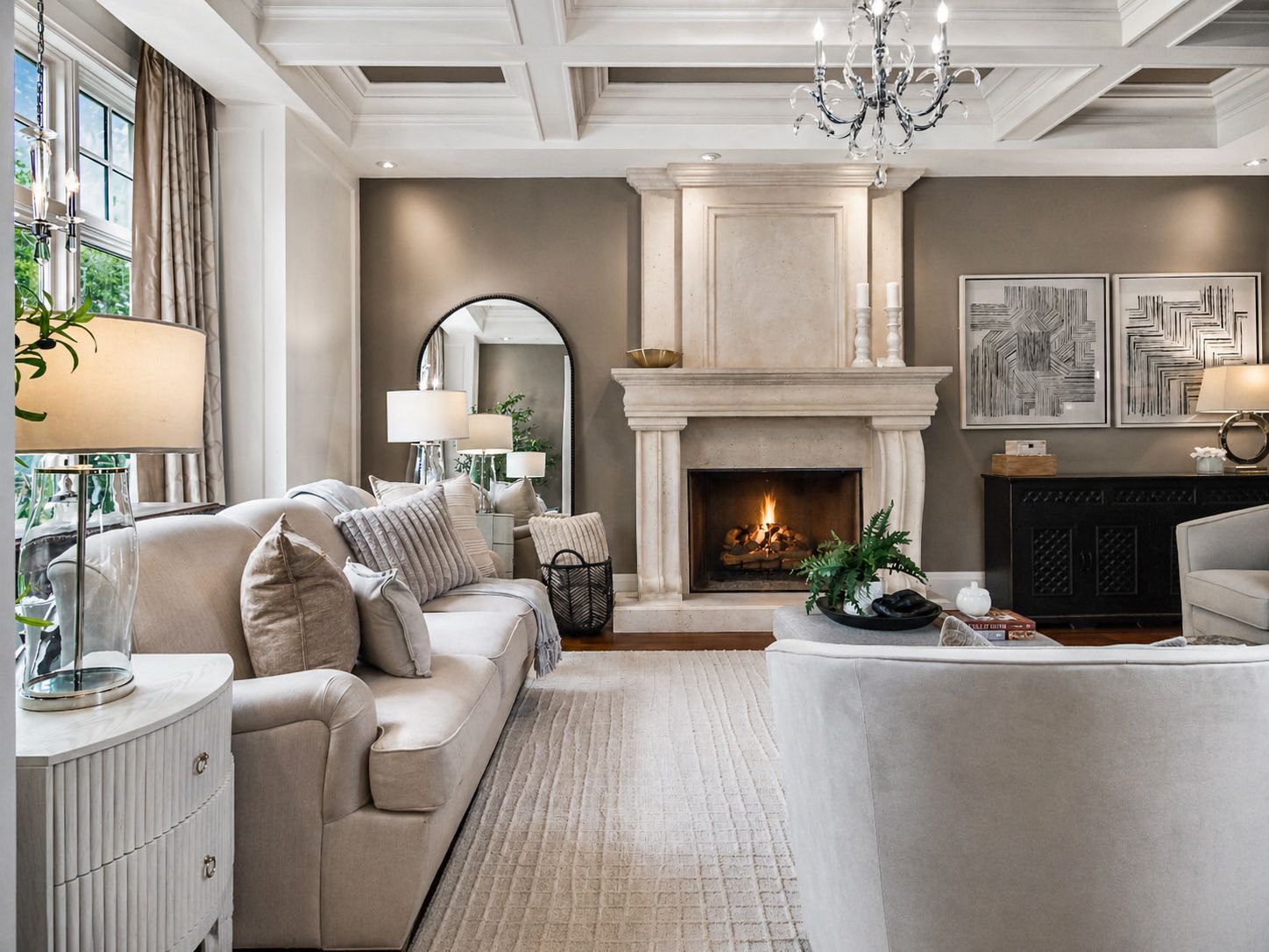 Elegant living room with beige sofa, fireplace, and large windows in neutral tones