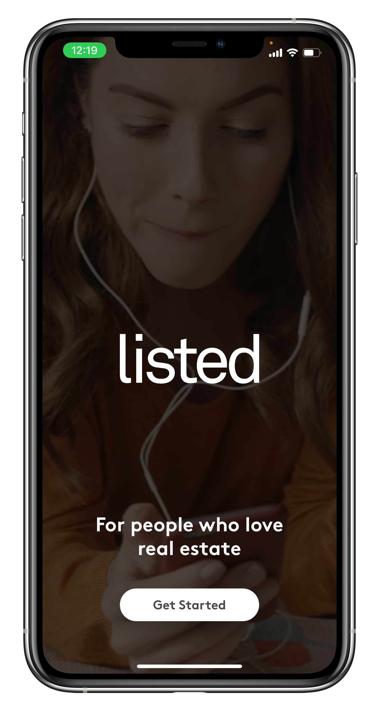 A woman is listening to music on a cell phone.