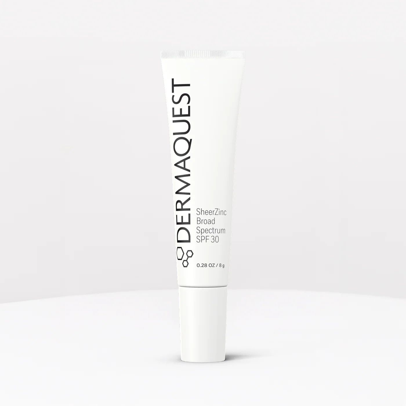 White DERMAQUEST skincare tube standing upright on a light background.