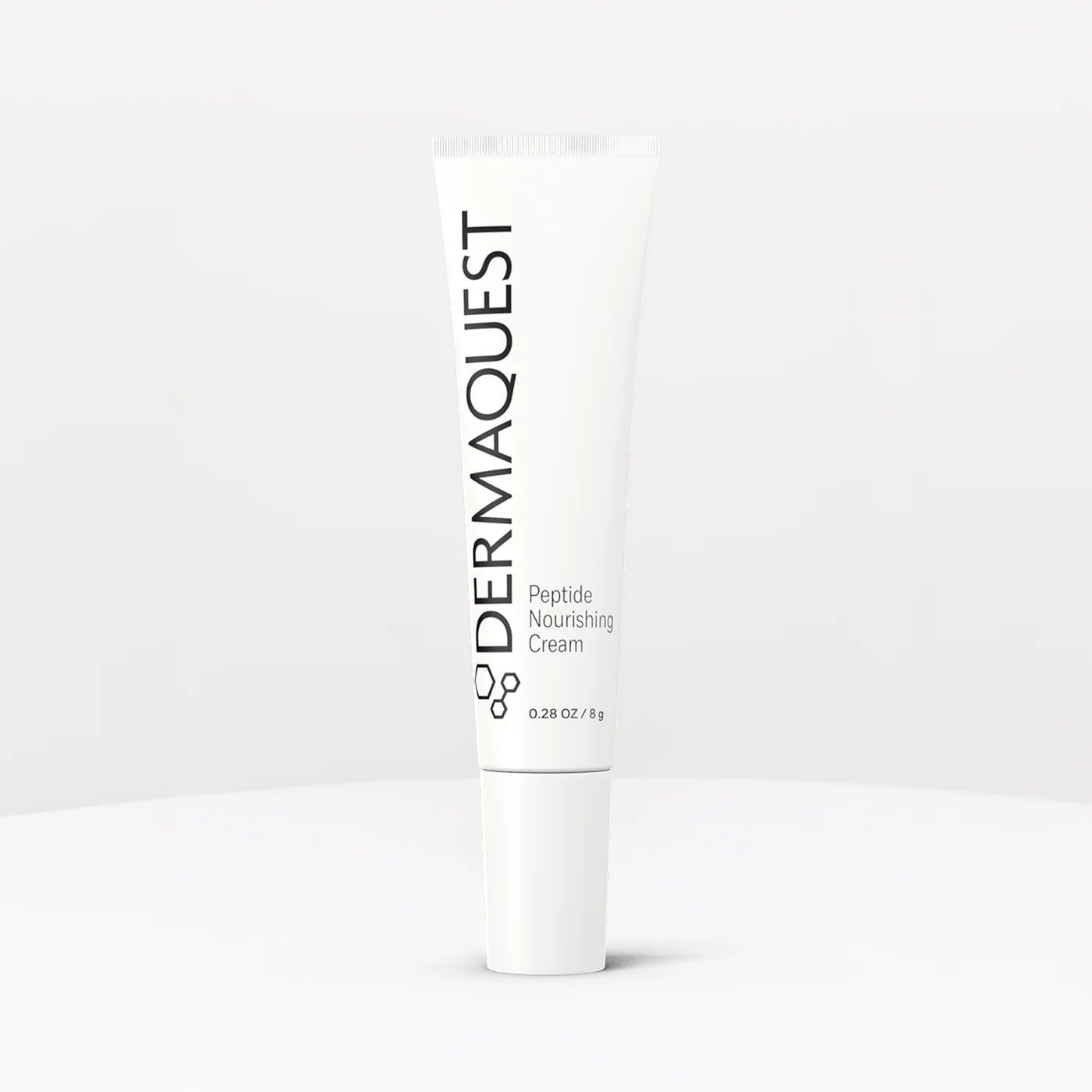 White DERMAQUEST skincare tube on a light background.