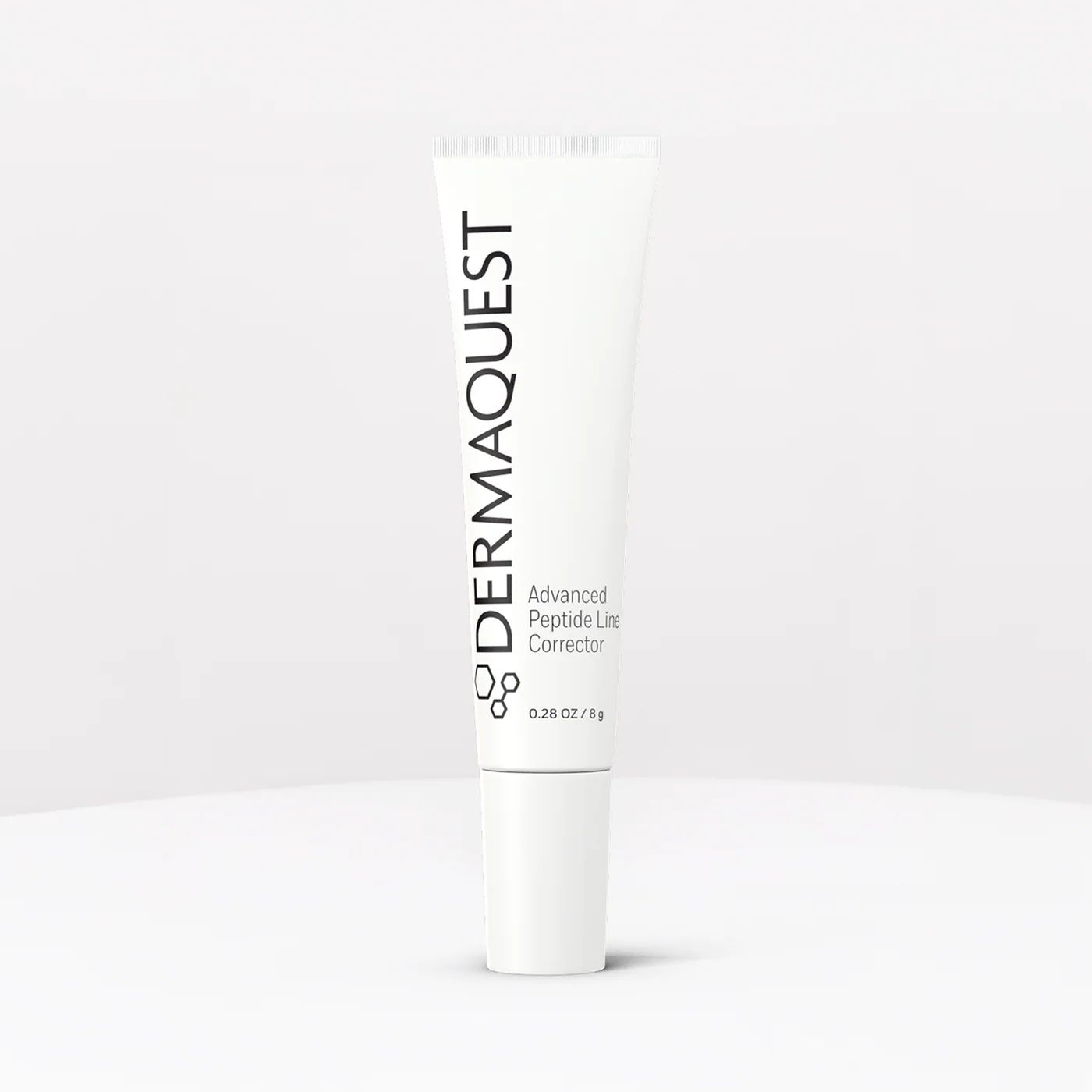 White DERMAQUEST skincare tube standing upright on a light background