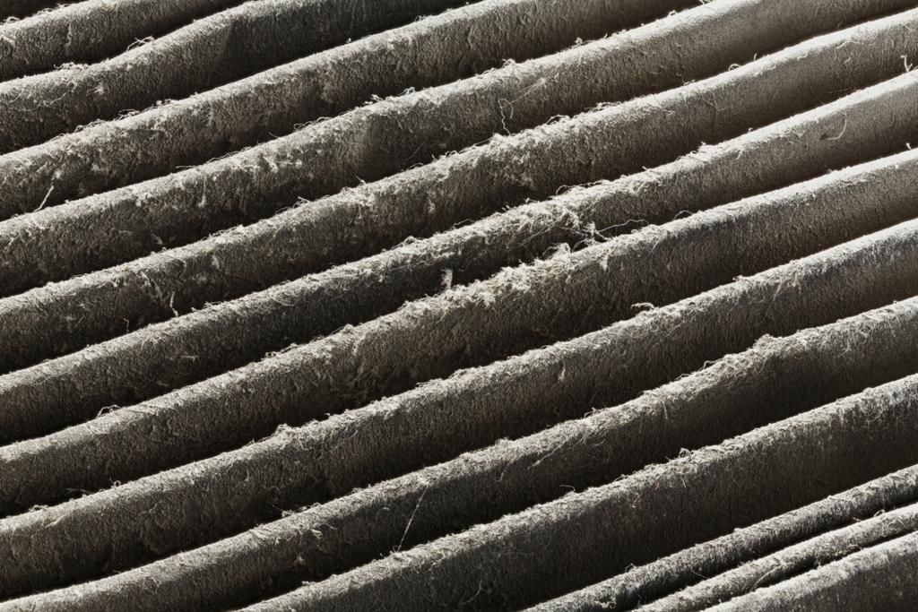 A close up of a dirty air filter with a lot of dust on it