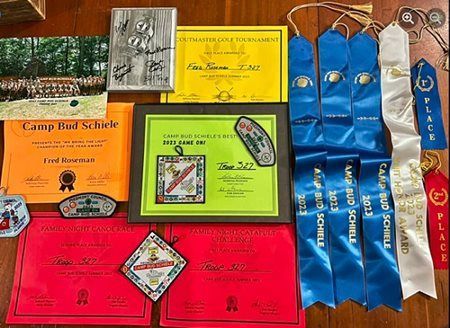 A bunch of ribbons and certificates are on a table