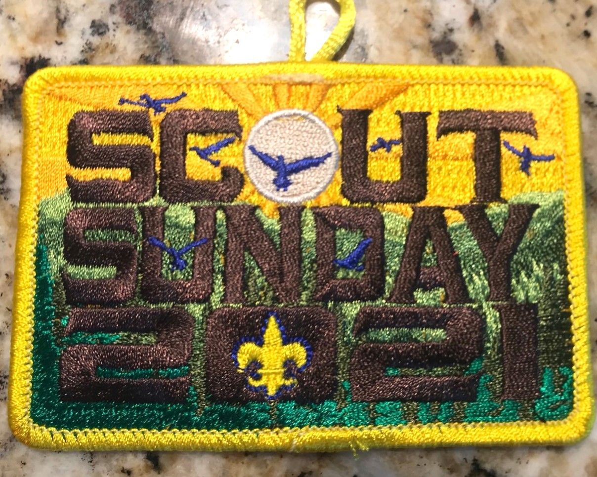 “Scout Sunday” patch with yellow border, dark green text, and a blue eagle emblem on a speckled background