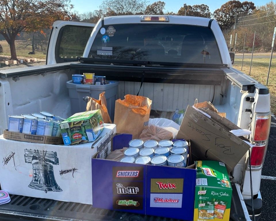 Pickup truck bed filled with boxed and canned food donations outdoors
