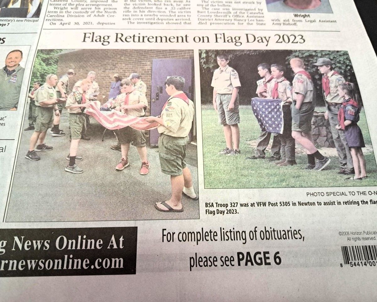Newspaper page showing a Flag Retirement on Flag Day 2023 ceremony with scouts and flags outdoors