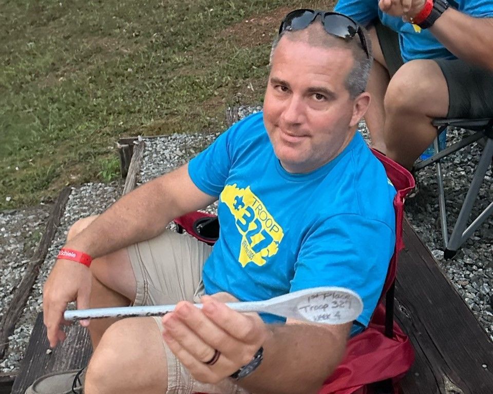 A man wearing a blue shirt with the number 377 on it