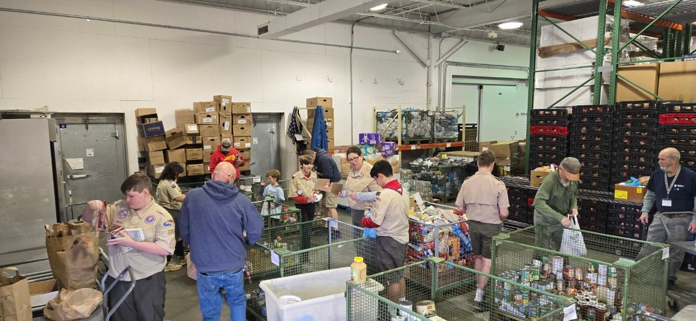 A group of people are working in a warehouse.