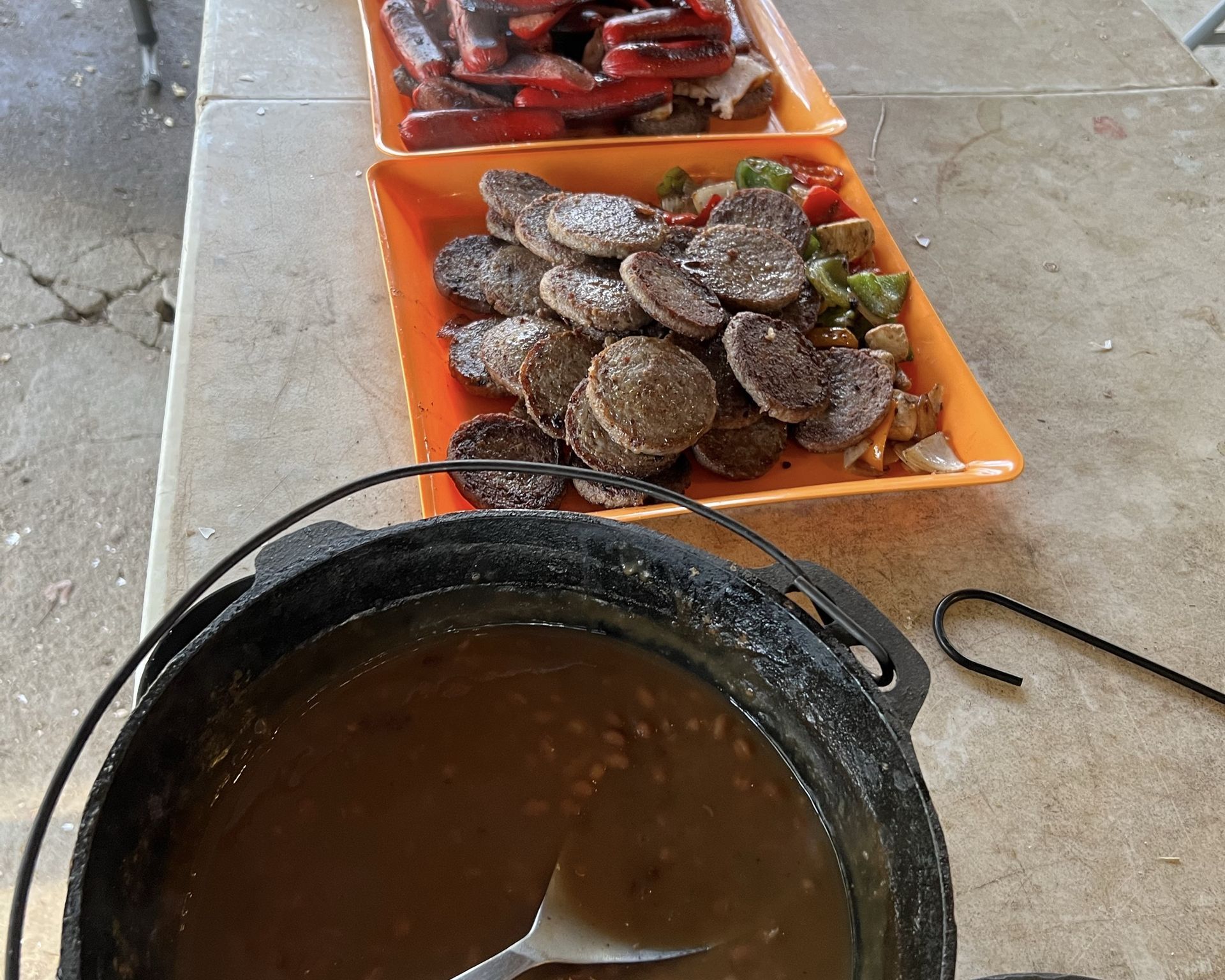 A table with plates of food and a pot of sauce