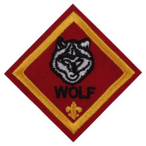 A red badge with a wolf and the word wolf on it